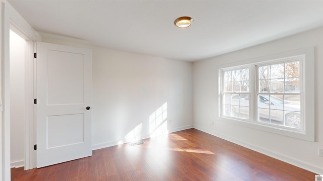 empty room featuring dark wood-type flooring