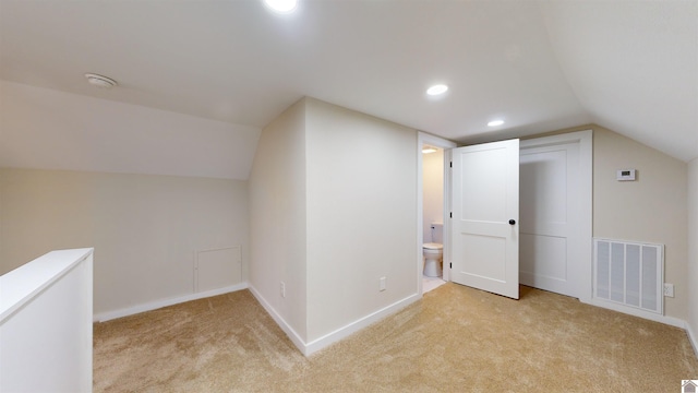 bonus room featuring vaulted ceiling and light carpet