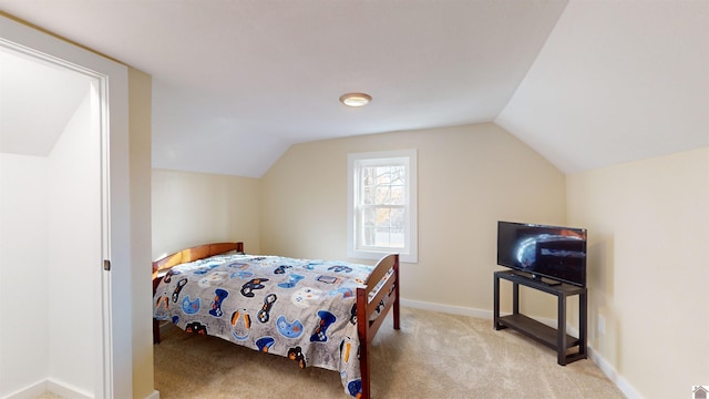 carpeted bedroom with vaulted ceiling