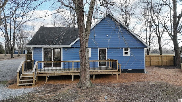 back of property with a wooden deck