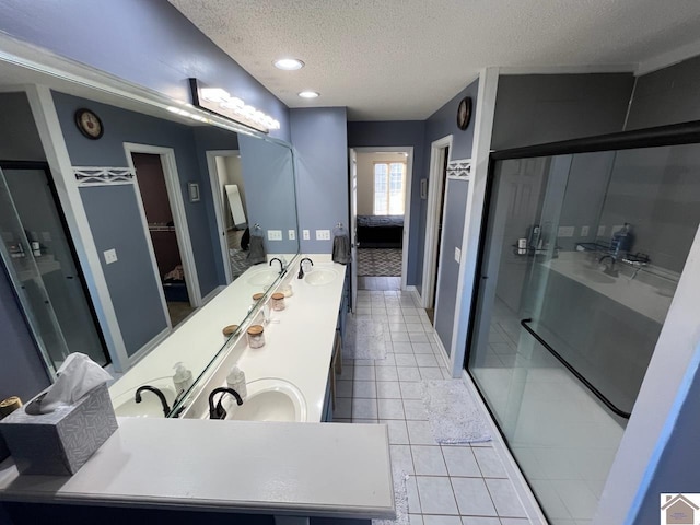 bathroom with vanity, tile patterned floors, a textured ceiling, and walk in shower