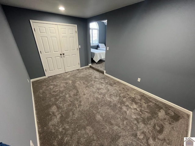 unfurnished bedroom with a closet and carpet