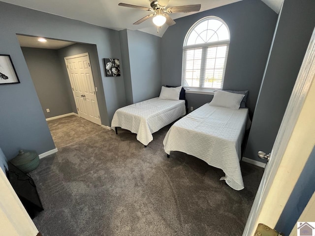 carpeted bedroom featuring ceiling fan, vaulted ceiling, and a closet