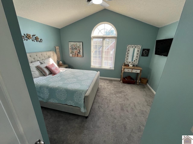 bedroom featuring vaulted ceiling, carpet floors, a textured ceiling, and ceiling fan