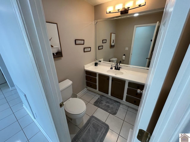 bathroom with vanity, tile patterned floors, and toilet