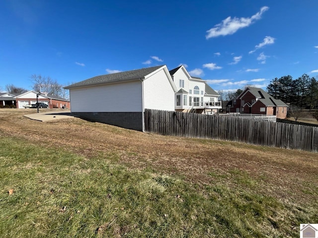 view of side of property with a lawn