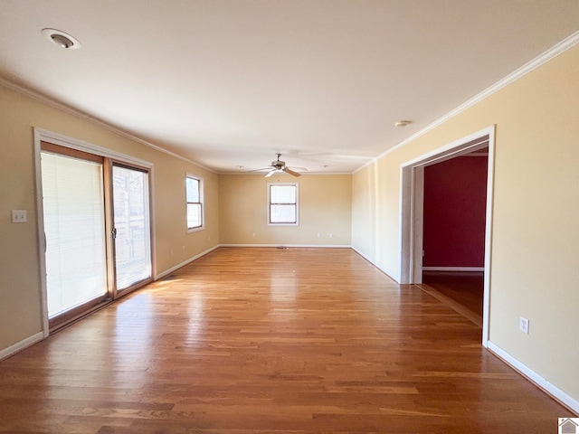 unfurnished room featuring ceiling fan, ornamental molding, and wood-type flooring