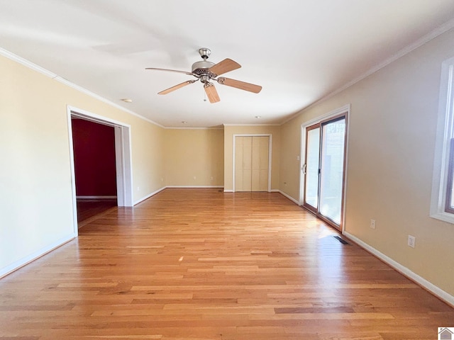 spare room featuring crown molding, ceiling fan, and light hardwood / wood-style floors