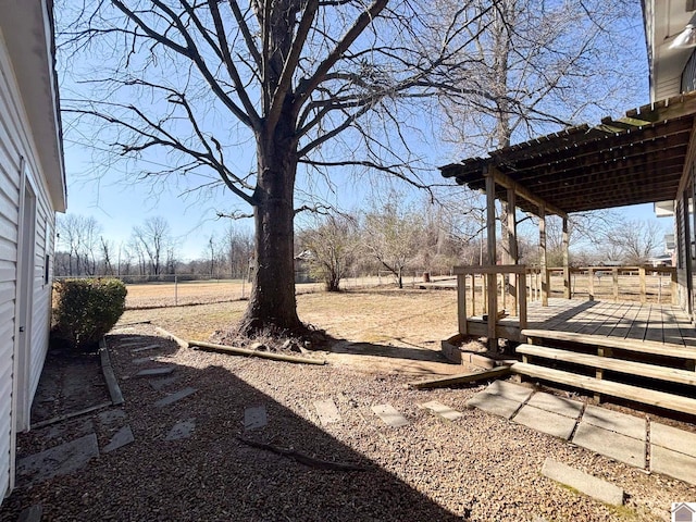 view of yard with a rural view and a deck