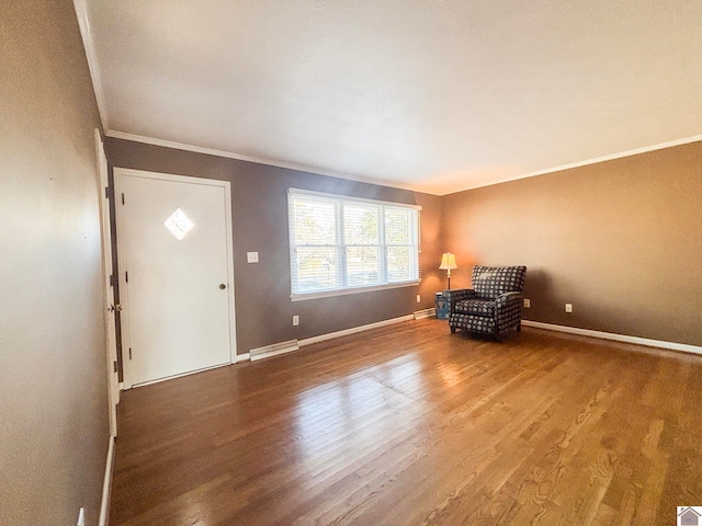 unfurnished room with ornamental molding and hardwood / wood-style floors