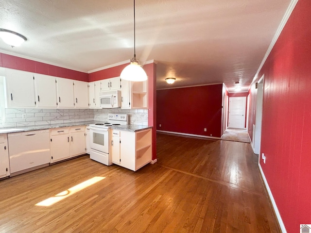 kitchen featuring white appliances, light hardwood / wood-style flooring, hanging light fixtures, white cabinets, and decorative backsplash