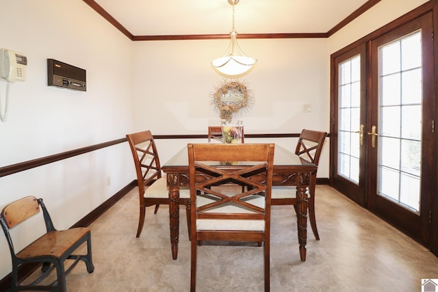 dining space featuring ornamental molding and french doors