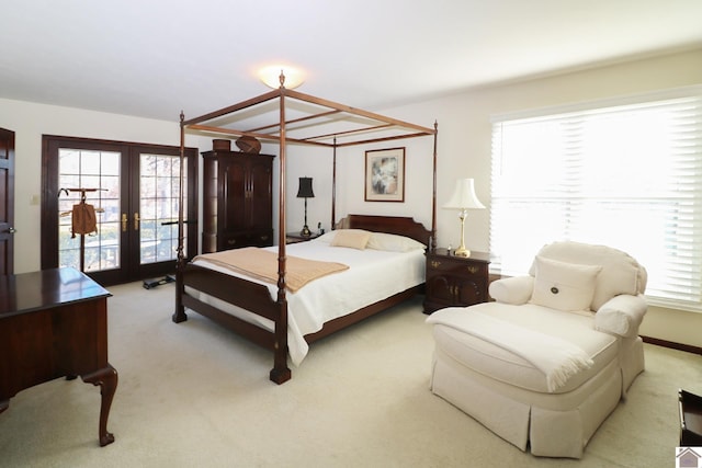 bedroom with french doors and light carpet