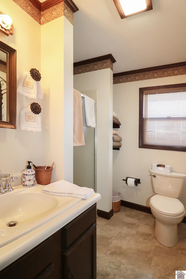 bathroom featuring crown molding, vanity, and toilet