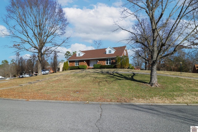 cape cod-style house with a front lawn