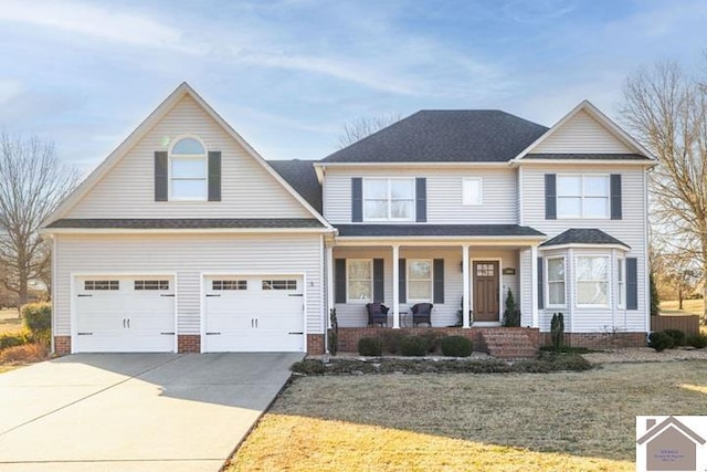 view of front facade with a garage, covered porch, and a front yard