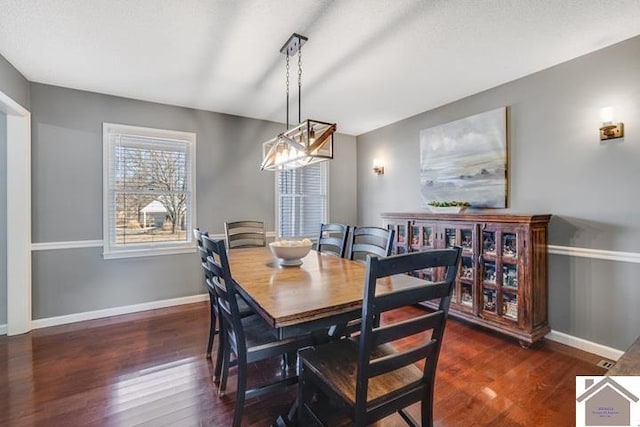 dining area featuring dark hardwood / wood-style floors and a textured ceiling