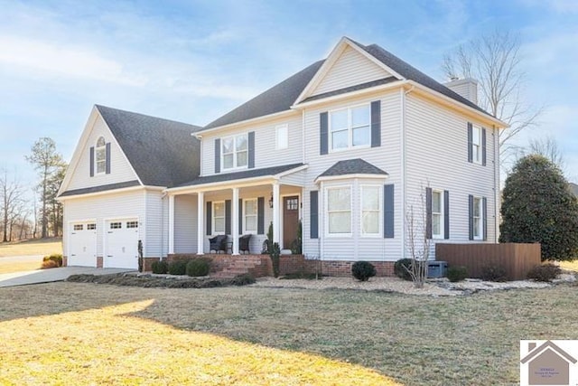 front of property with a garage, a front yard, and a porch