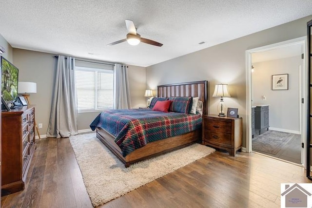 bedroom featuring a textured ceiling, dark wood-type flooring, and ceiling fan