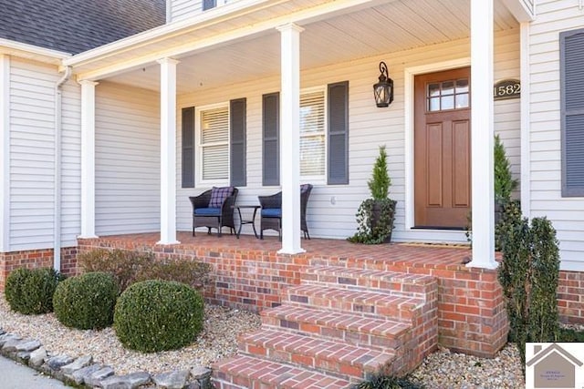 view of exterior entry with covered porch