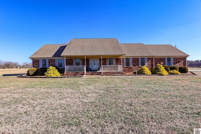 ranch-style house featuring a porch and a front yard