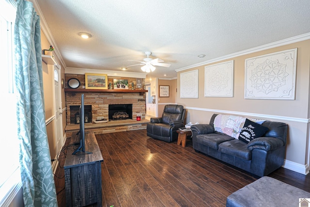 living room with ornamental molding, a stone fireplace, dark wood-type flooring, and a textured ceiling