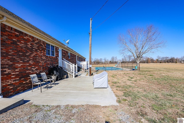 view of yard with a swimming pool and a patio