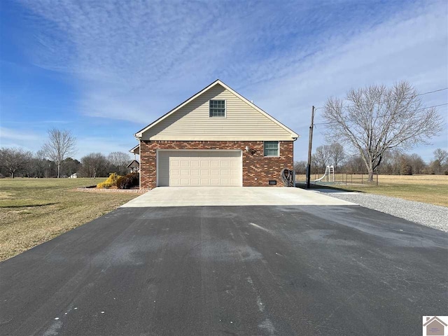 view of home's exterior featuring aphalt driveway, a garage, a lawn, and brick siding