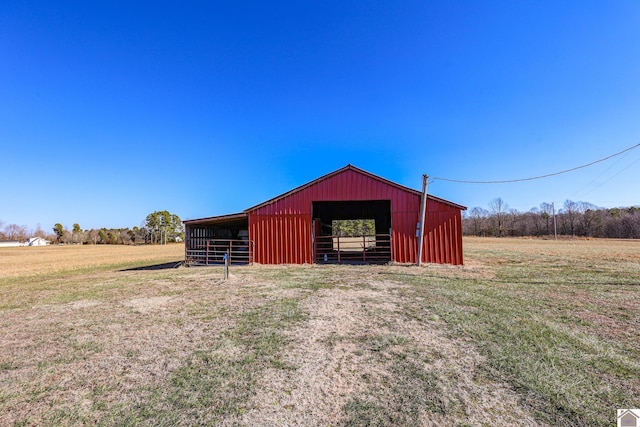 view of outdoor structure with a rural view and a yard