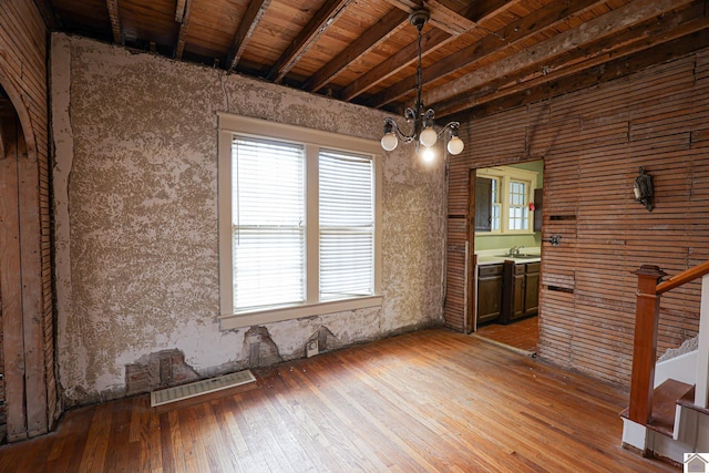 interior space featuring sink, beam ceiling, wood-type flooring, and wooden ceiling