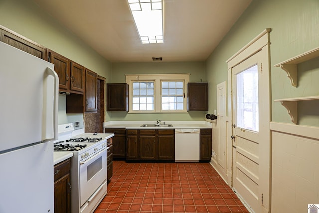 kitchen with dark brown cabinets, sink, a wealth of natural light, and white appliances