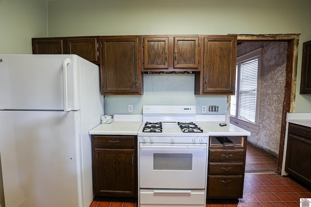 kitchen with white appliances and dark brown cabinetry