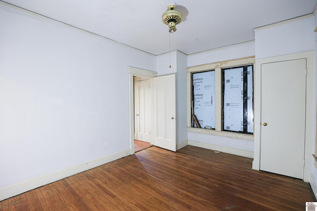 unfurnished bedroom featuring dark hardwood / wood-style flooring