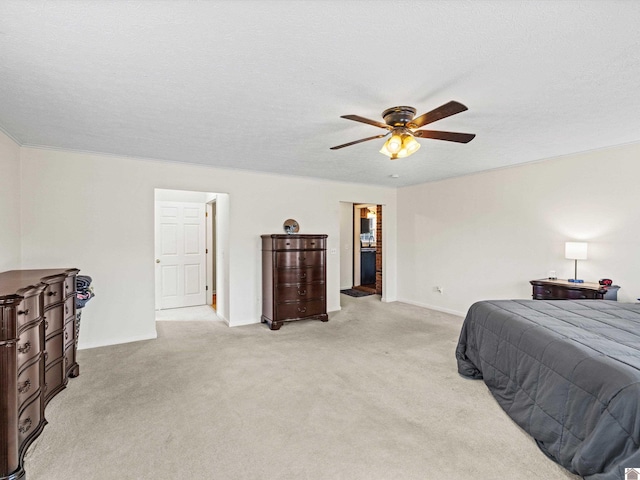 carpeted bedroom featuring ceiling fan and a textured ceiling