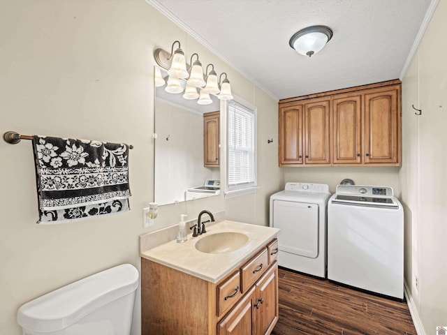 laundry area with washer and dryer, sink, crown molding, dark wood-type flooring, and a textured ceiling