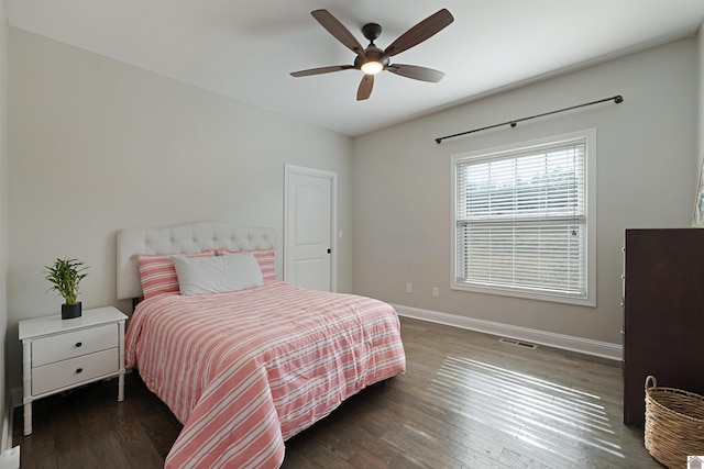 bedroom with dark hardwood / wood-style floors and ceiling fan