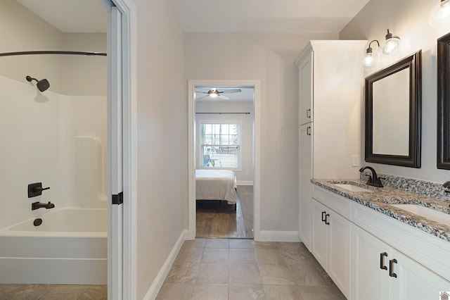 bathroom with tile patterned flooring, vanity, and shower / bathtub combination