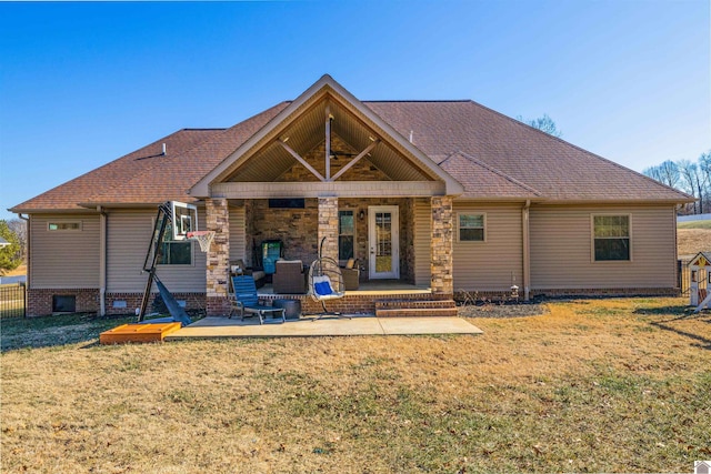 back of house featuring a lawn and a patio