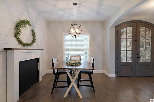 dining area featuring french doors, dark hardwood / wood-style floors, and a chandelier