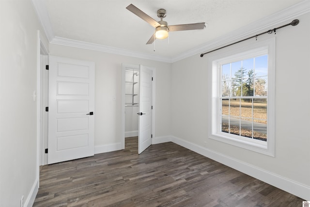 unfurnished bedroom featuring dark wood-type flooring, ceiling fan, ornamental molding, and a closet