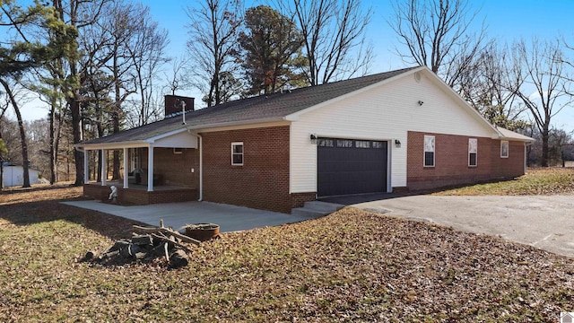 view of home's exterior with a garage and covered porch