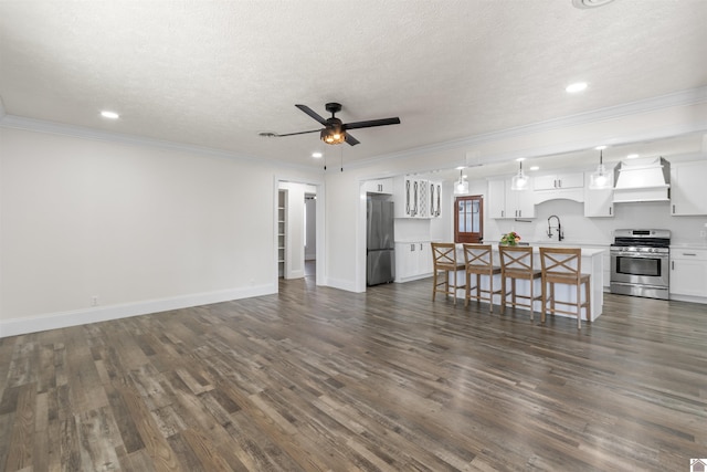 living room with ceiling fan, sink, crown molding, and dark hardwood / wood-style floors