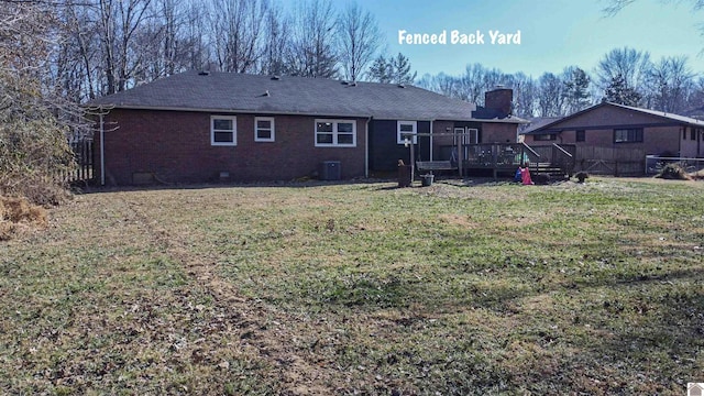 back of house with central AC unit, a lawn, and a deck