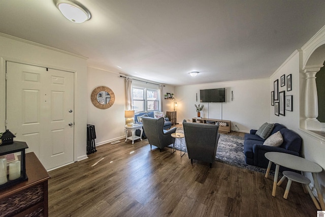 living room with crown molding and dark wood-type flooring