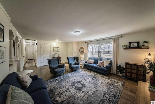 living room featuring crown molding, decorative columns, and dark hardwood / wood-style floors