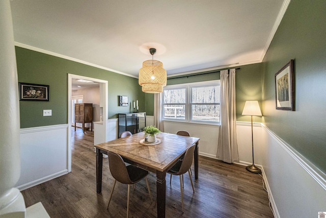 dining area with crown molding and dark wood-type flooring