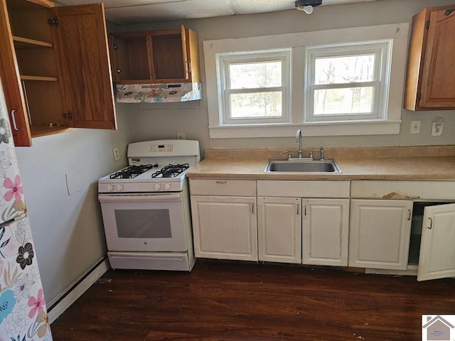 kitchen with sink, dark hardwood / wood-style flooring, and white gas range oven