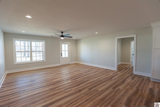 interior space with dark wood-type flooring and ceiling fan