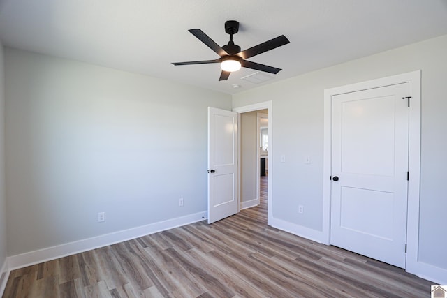 unfurnished bedroom with ceiling fan and light wood-type flooring