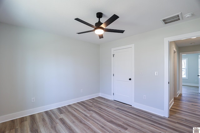 unfurnished bedroom with ceiling fan and light hardwood / wood-style flooring